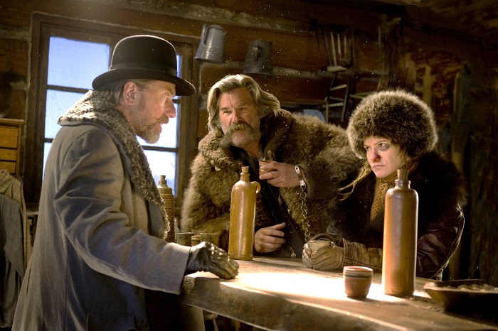 (L-R) TIM ROTH, KURT RUSSELL, and JENNIFER JASON LEIGH star in THE HATEFUL EIGHT. Photo: Andrew Cooper, SMPSP © 2015 The Weinstein Company. All Rights Reserved.