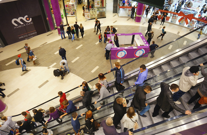 POZNAN, POLAND - OCTOBER 26, 2013: People using the escalator and the busy shopping mall Poznan City Center